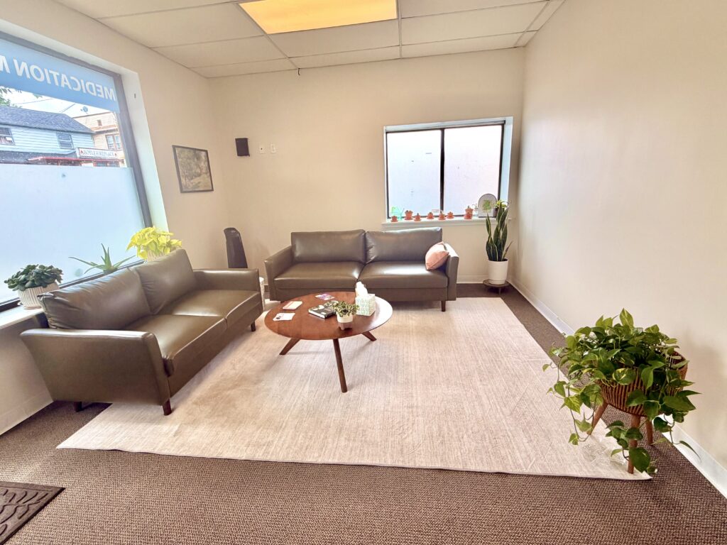 The waiting room at Keystone Psychiatry, with leather sofas and plants